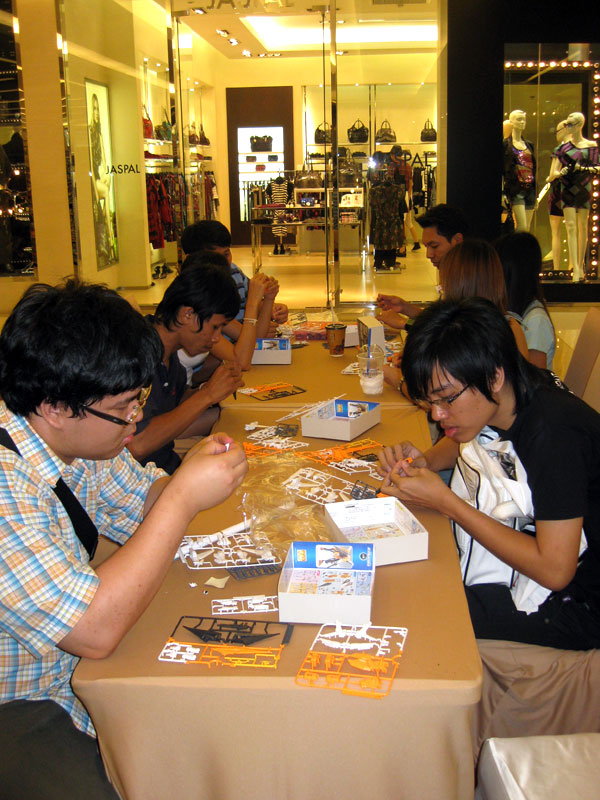 Gundam fans were working on their models right at the exhibition.